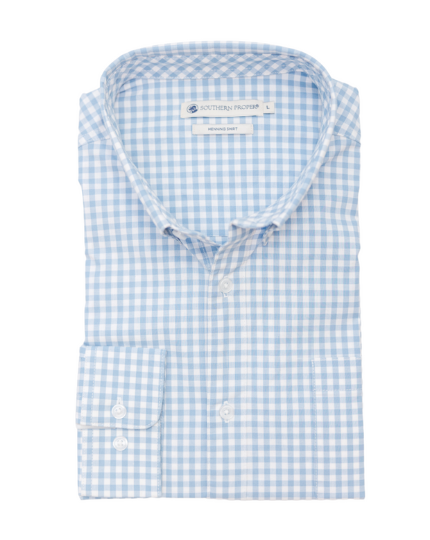 A blue and white gingham dress shirt, perfect for strolling the streets of New Orleans or wearing to a stylish event. The Henning Shirt: St. Charles exudes classic charm with its timeless design.