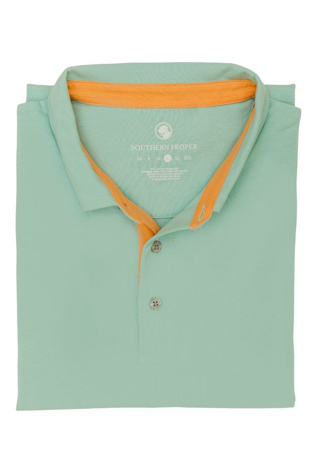 A men's Lakeside Polo shirt in mint green, made with soft cotton and featuring orange trim.