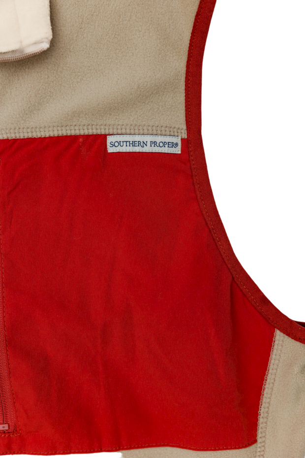A lightweight All Prep Vest in red and beige, perfect for the golf swing or all prep occasions.