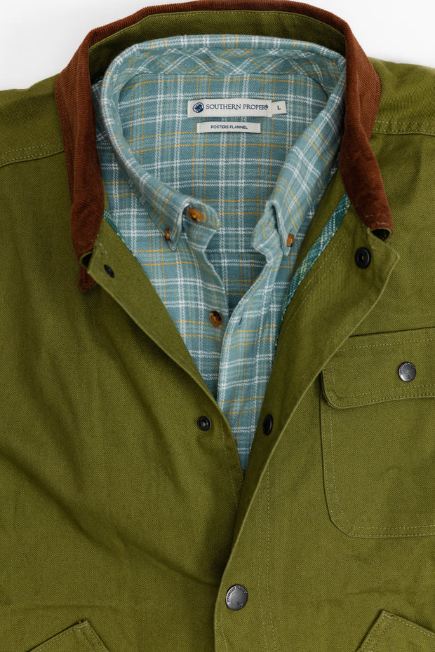 A Bluff Barn Jacket with a cotton canvas and plaid collar.