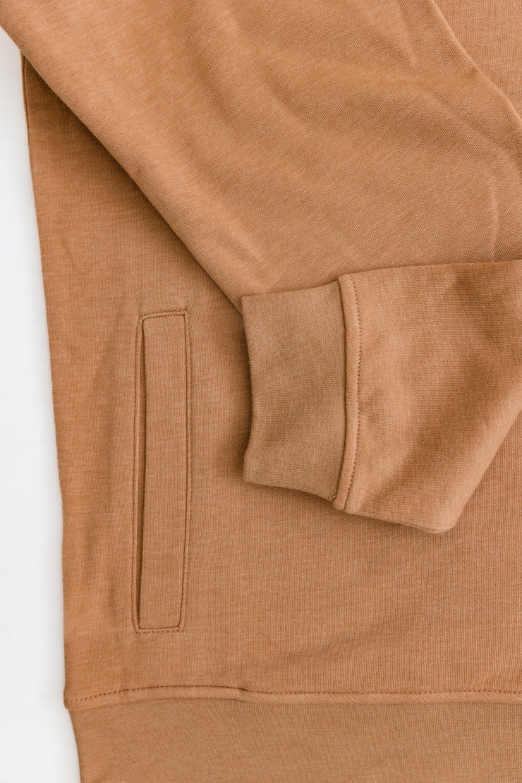 A close up of the Poydras Hoodie, a tan sweatshirt with a relaxed fit.