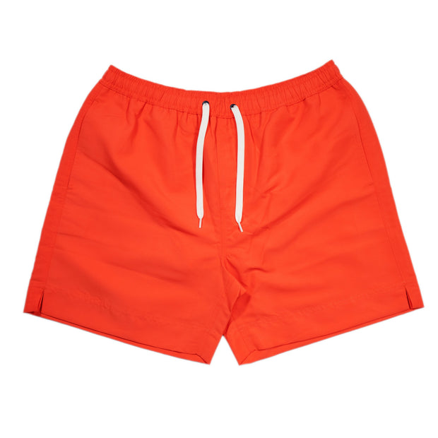 A pair of orange Southern Swim 5.5" swim shorts with an elastic waistband, shown on a white background.