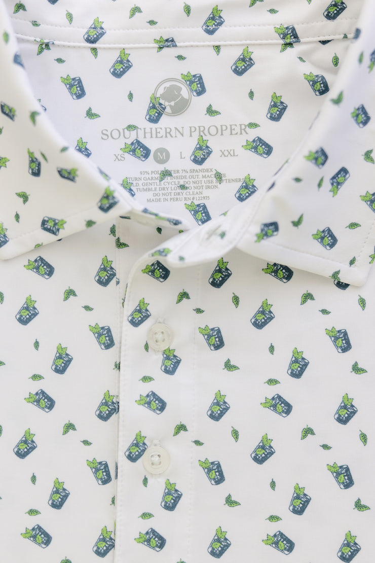 A Mint Julep Printed Performance Polo shirt featuring blue and green plants, perfect for the Kentucky Derby.
