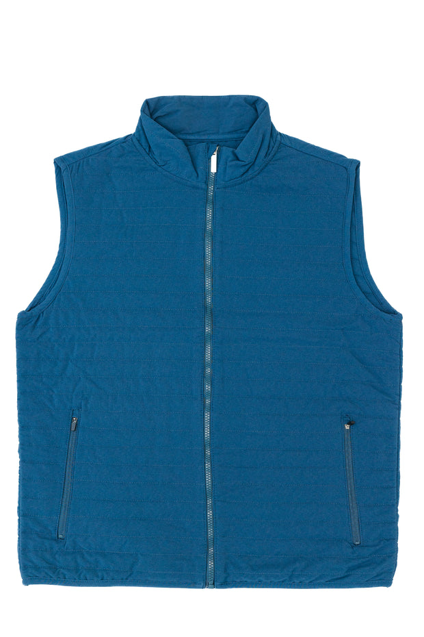 A blue Quilted Field Vest with zippered pockets, featuring polyester insulation for added warmth.