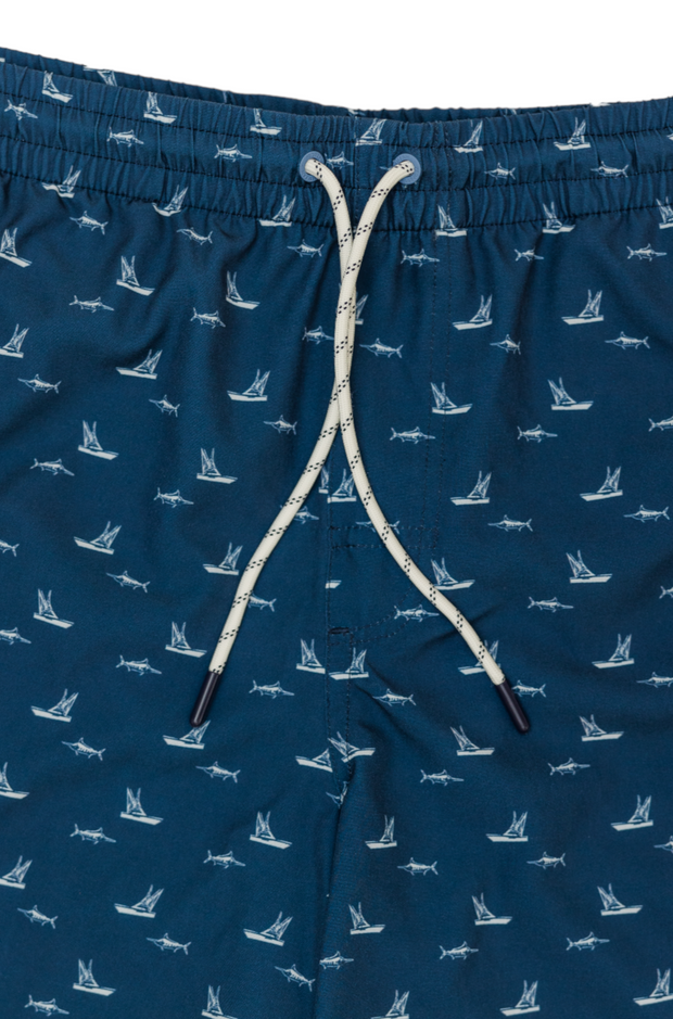Chasing Blues Swim: Navy trunks from the Spring 23 Keys collection, with white airplanes on a men's blue swim trunks.