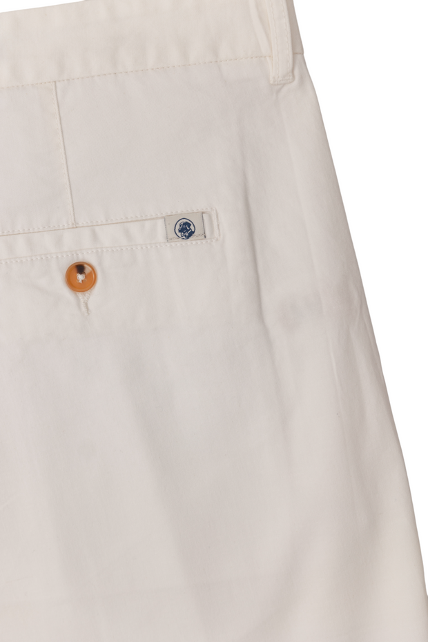 A pair of Bluff Shorts: White with a button on the side.