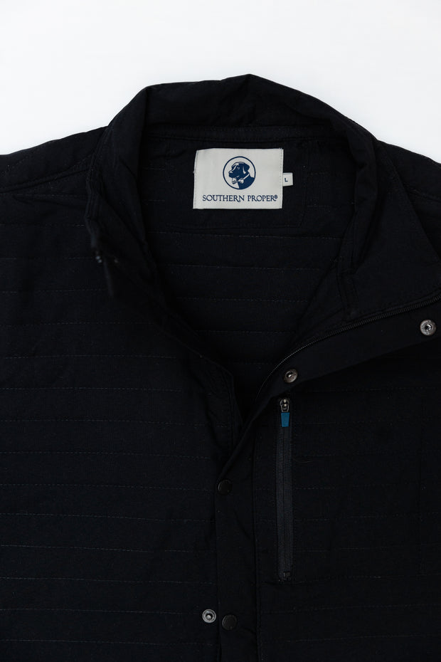 A versatile Quilted Field Jacket with a blue label on it.