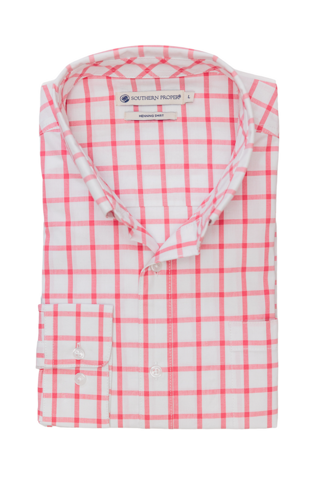 A pink and white checkered Bienville Woven Shirt on a white background in downtown Mobile.