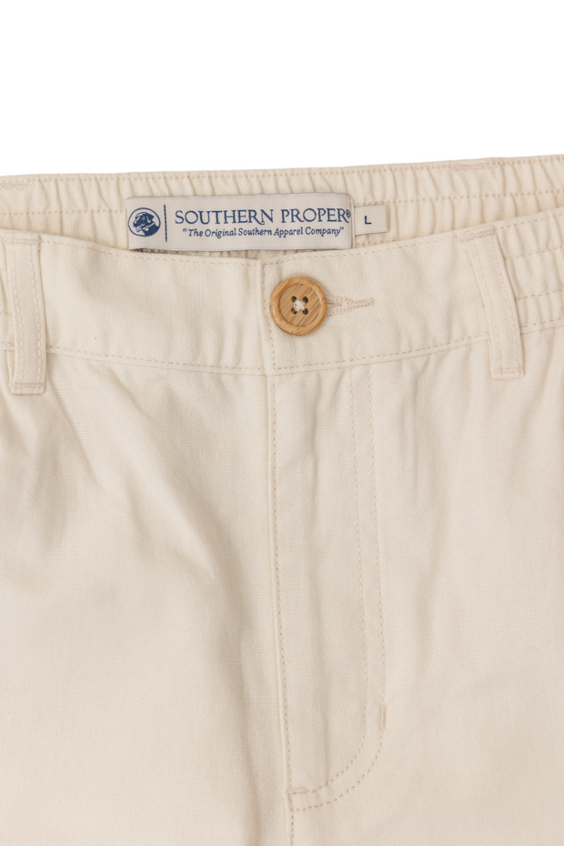 A pair of PC shorts: Stone with buttons on the side.