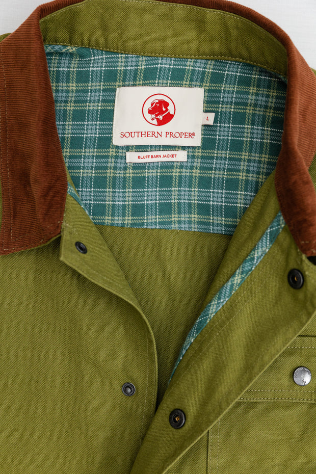 A close up of a Bluff Barn Jacket with a checkered collar made of cotton canvas.