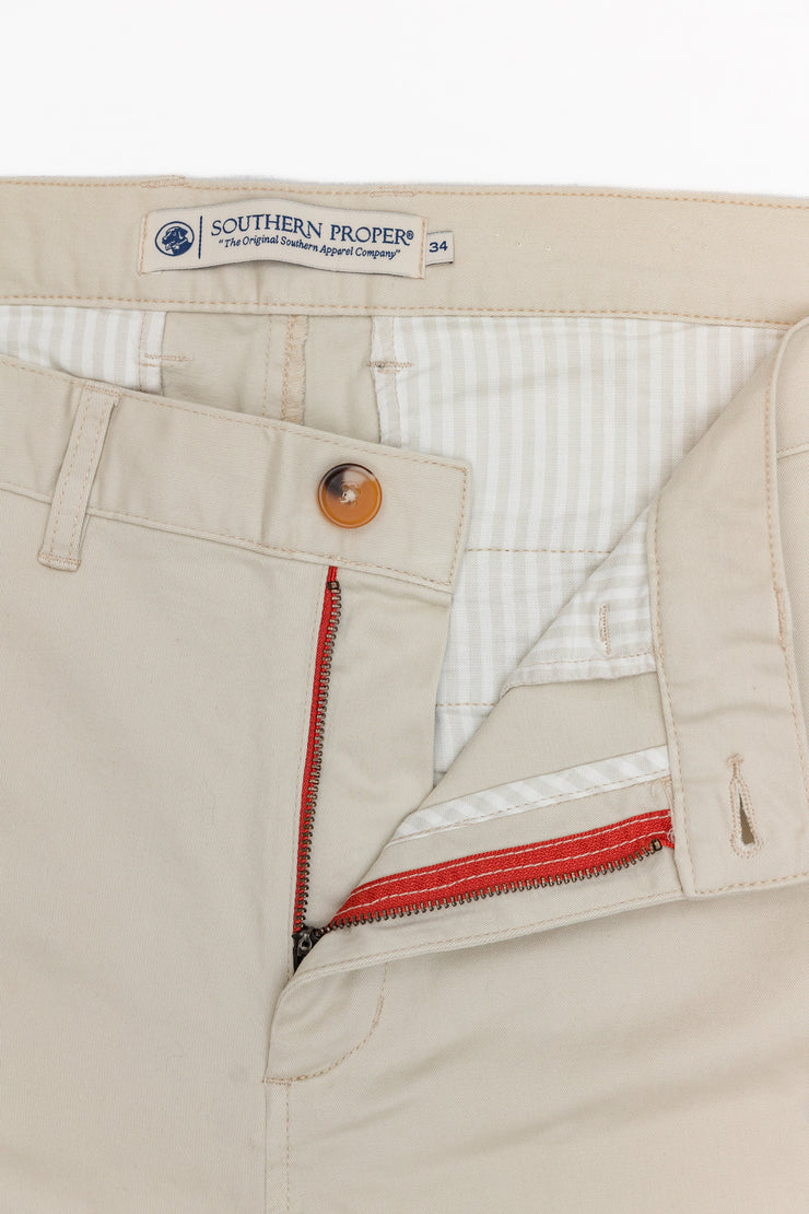 A pair of Thomasville Pant beige chino pants with a red zipper.