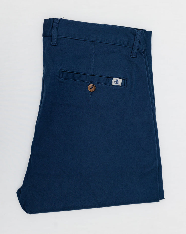 A pair of blue Thomasville Pant with a tailored fit on a white surface.