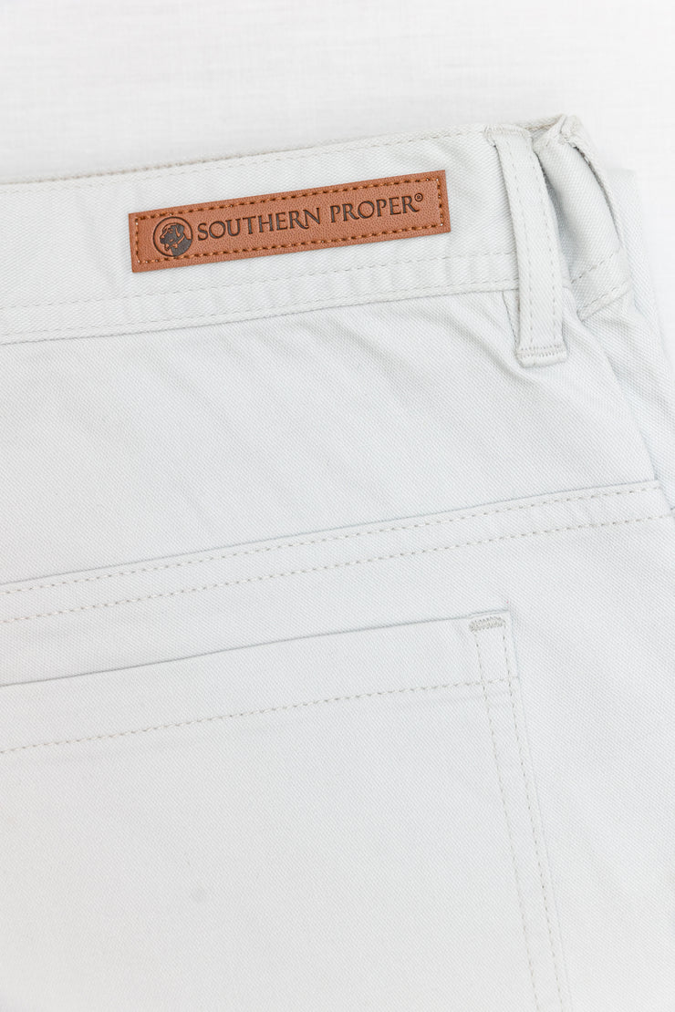 A pair of Needle Creek Five Pocket Pant with a brown leather Southern Proper stamped patch.