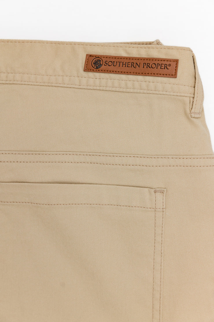 A pair of Needle Creek Five Pocket Pants with a Classic Straight Leg and a leather Southern Proper Stamped Patch.