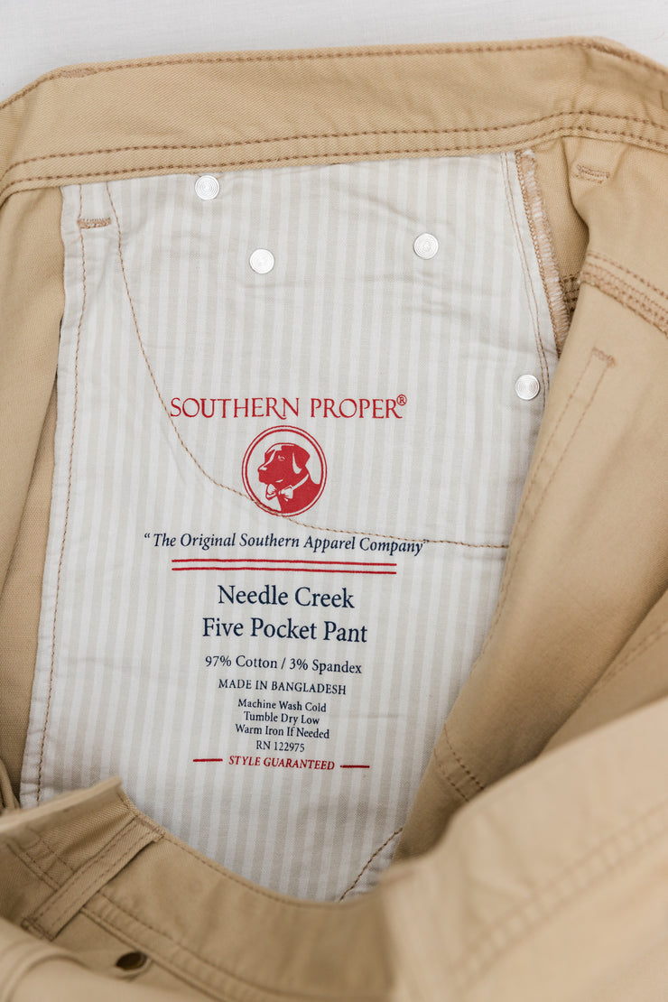 A pair of Needle Creek Five Pocket Pants with a Classic Straight Leg and a Stamped Patch on the back.