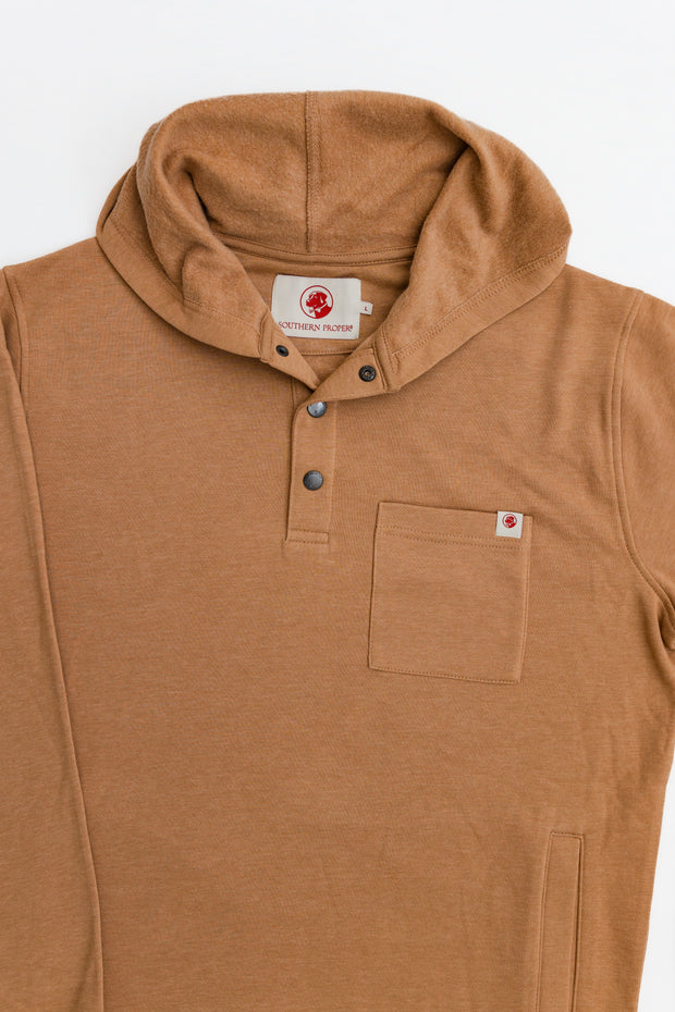 The Poydras Hoodie is a relaxed fit Southern comfort essential, featuring a tan color and front pocket.