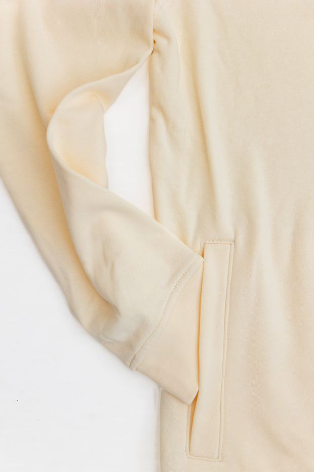 A close up of a relaxed fit Poydras Hoodie on a white surface.