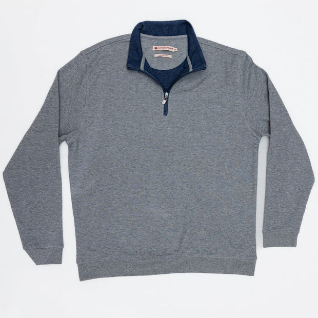 A men's grey sweater with a blue zipper, also known as a Canal Quarter Zip.