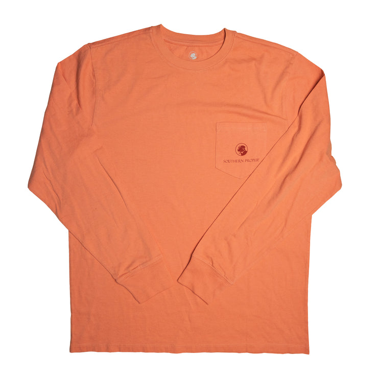 A long-sleeved orange Southern Comforts LS Tee with a pocket made of Peruvian cotton blend.