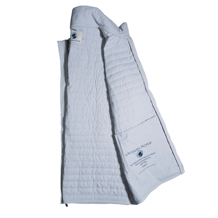 A white quilted field vest on a white background.