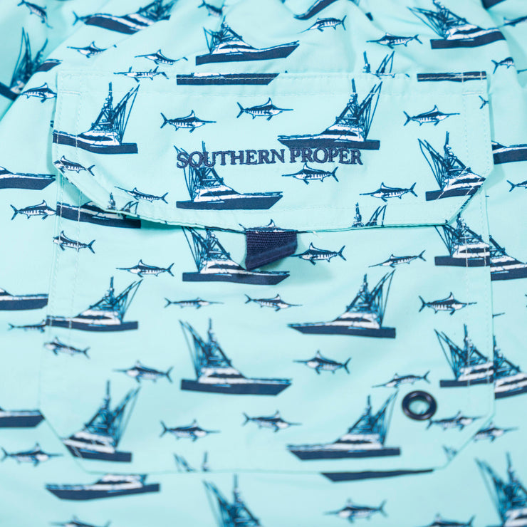 A pair of Southern Swim 7.5" swim trunks featuring sharks and boats, perfect for a day at the shore.